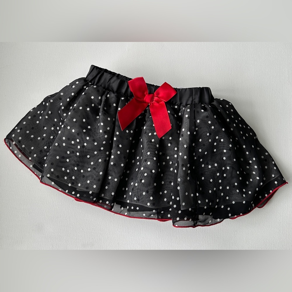 Disney girl’s tulle skirt, white polka dots, red bow at the waistband. Size 18M,